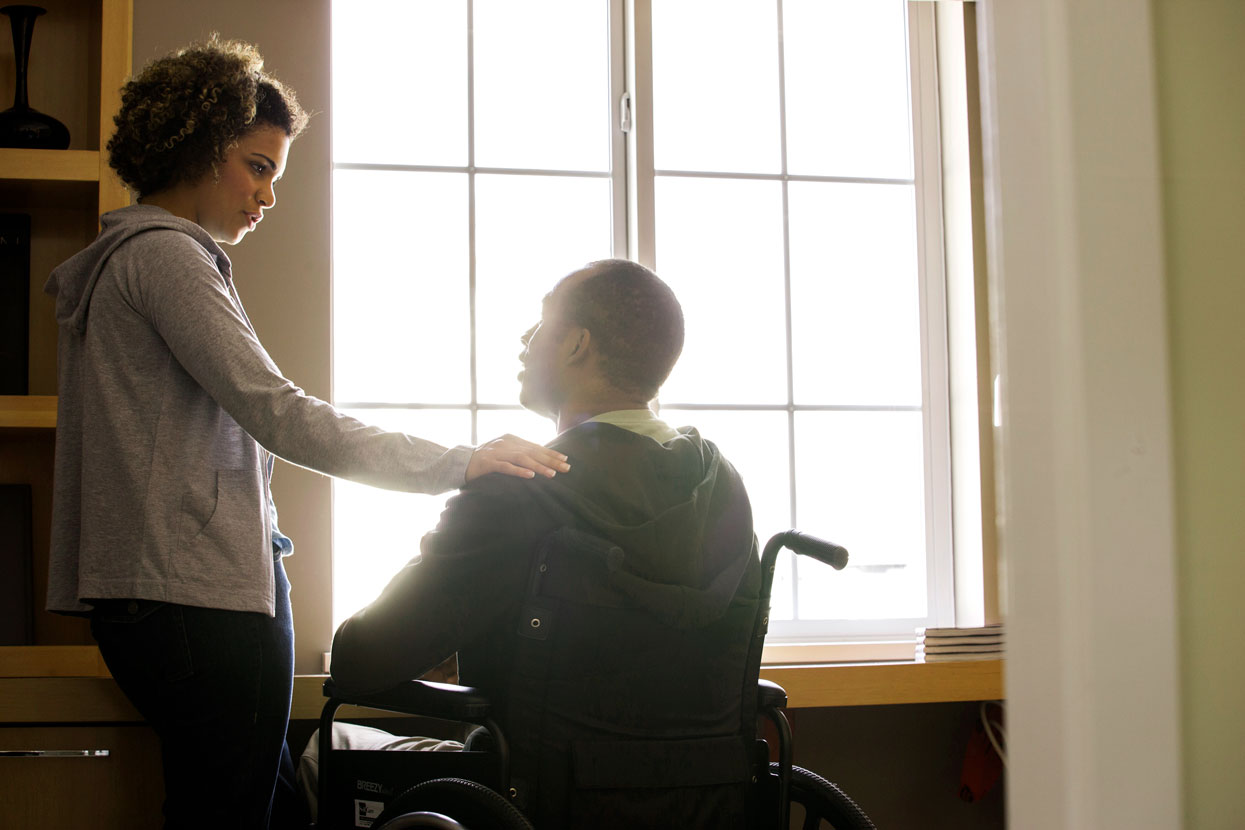 Woman with man in wheel chair